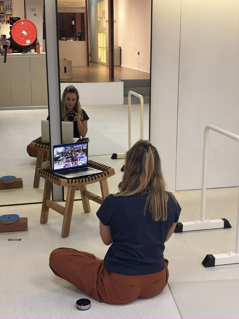 Coach leading a live remote session by laptop in the studio