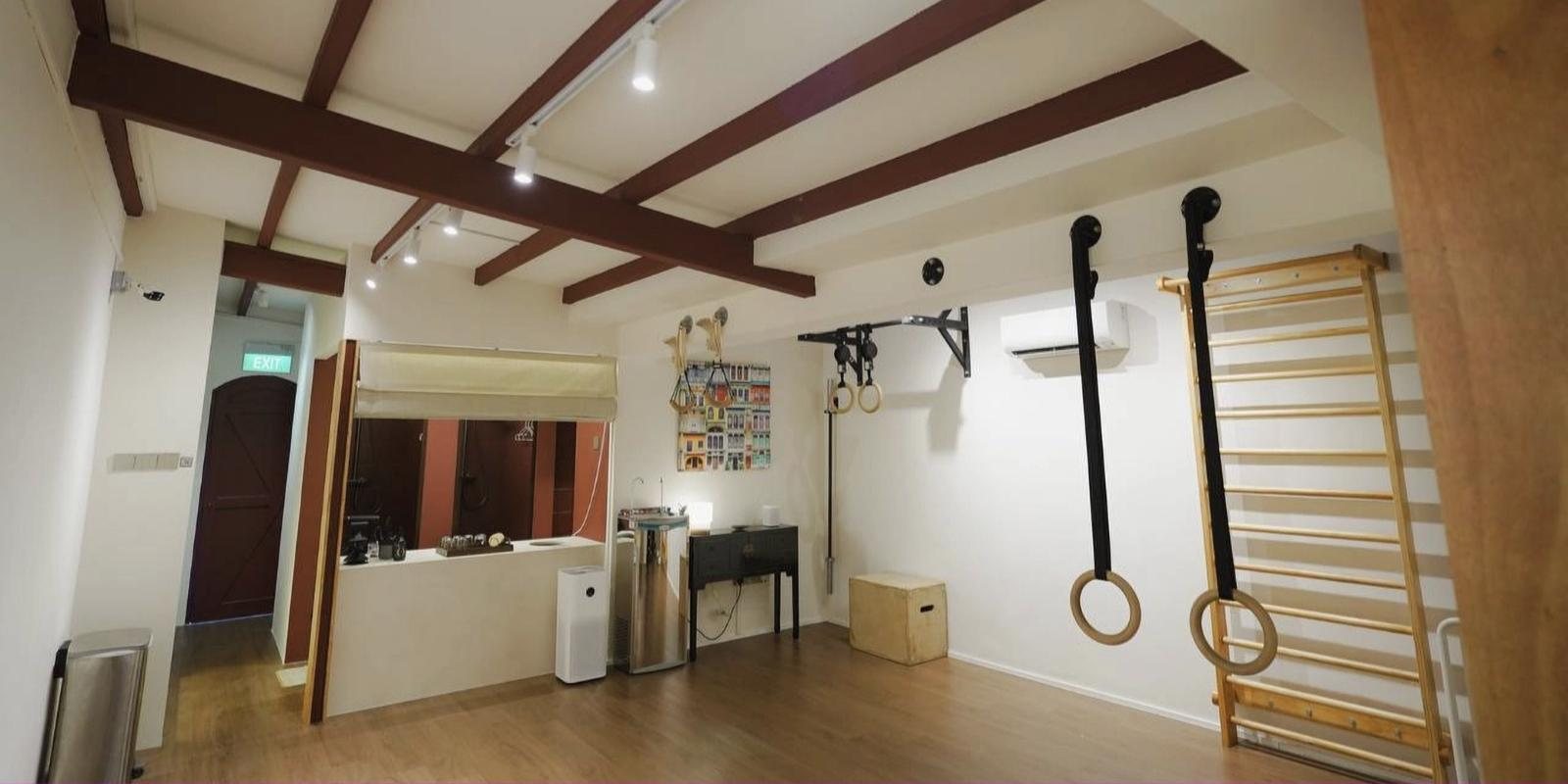 The Uncommon Movement Studio space on Cantonment Road with rings, wall bars and timber beams